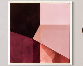 May include: A square framed wall art piece featuring a geometric composition of deep burgundy, dark brown, and soft pink color blocks. The artwork is displayed on a plain wall above a red velvet bench with a textured gray throw blanket draped over it.