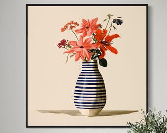 May include: A square framed wall art print featuring a bouquet of vibrant orange and red flowers arranged in a rounded vase with horizontal navy blue and white stripes, set against a solid light beige background within a thin black frame.