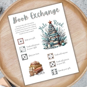 May include: A printed game card for a "Book Exchange" with a Christmas theme. The card features a watercolor illustration of a Christmas tree made of books, dice, and instructions for gameplay. The text includes "Book Exchange" and "Yule Read".