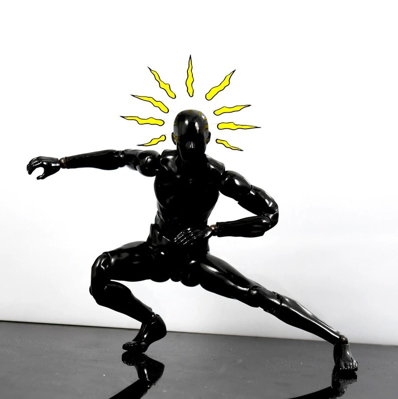 May include: A black action figure in a fighting pose with a yellow sunburst above its head.