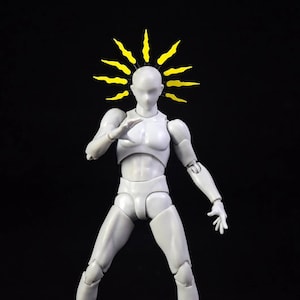 May include: A white articulated figure with a yellow spiky crown on its head. The figure is posed in a dynamic stance with one arm raised and the other extended to the side.