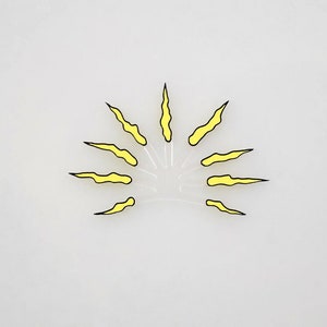 May include: A yellow sun with black outlines and jagged rays. The sun is on a white background.