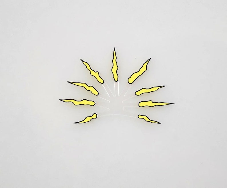 May include: A yellow sun with black outlines and jagged rays. The sun is on a white background.