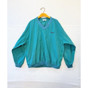 May include: Teal and blue IZOD windbreaker jacket with a V-neck collar and a small logo on the chest. The jacket has a drawstring hem and long sleeves with zippers. The jacket is hanging on a wooden hanger.