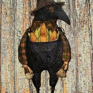 May include: A folk art doll depicting a black bird-like figure wearing a plaid shirt, overalls, and a pointed hat. The doll holds three corns in its chest. The text "Keeper of the Corn" is at the top, and "shp07-230" is at the bottom.