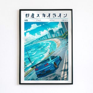 May include: A framed art print featuring a blue sports car driving along a coastal road. The artwork depicts a beach scene with buildings, blue water, and the Japanese text "日産 スカイライン". The car has a rear spoiler and gold-colored wheels.