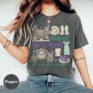 May include: Dark gray t-shirt with a graphic design featuring a house, carriage, teacup, gloves, and dress. Text includes "Dearest Gentle Reader" and "All is fair in love and poetry."