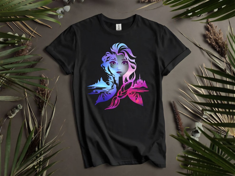 May include: Black t-shirt with a colorful graphic of Elsa from Frozen. The graphic features Elsa's face and hair, with a castle and ice crystals in the background.