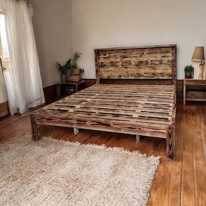 May include: A rustic wooden bed frame with a slatted headboard and footboard. The bed frame is made of reclaimed wood and has a natural, weathered finish.