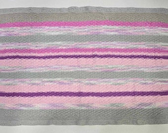 Pram/stroller blanket soft, cosy handmade knit in cotton in beautiful moss stitch hues of pink, mauve and grey, finished edge in crochet.