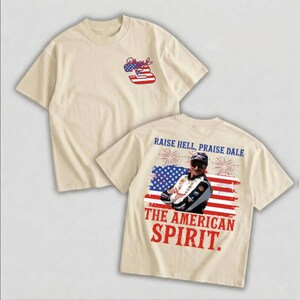 a beige t-shirt with a graphic design and text on the back.