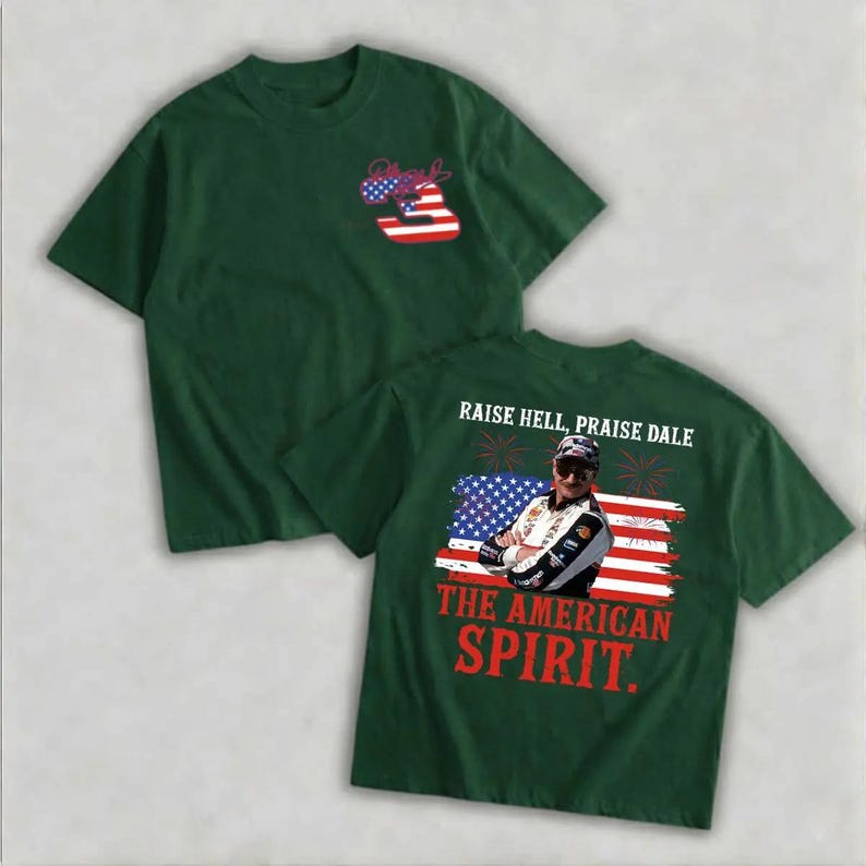 A green t-shirt with a graphic design featuring an American flag and a person wearing sunglasses. The text on the t-shirt reads "Raise Hell, Praise Dale" and "The American Spirit".