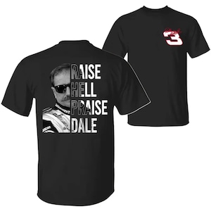 May include: Black t-shirts featuring a black and white image of a man with sunglasses and the text "RAISE HELL PRAISE DALE". The shirt also has the number 3 with a red outline.