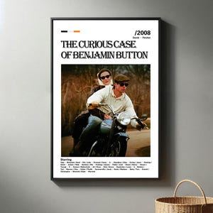 Könnte beinhalten: Ein Filmplakat für den Film "Der seltsame Fall des Benjamin Button" mit Brad Pitt und Cate Blanchett. Das Plakat zeigt ein Schwarzweißbild der beiden Schauspieler auf einem Motorrad. Der Text auf dem Plakat ist in Weiß und Schwarz.