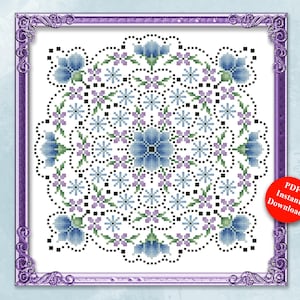 May include: A digital cross-stitch pattern featuring a floral mandala design in shades of blue, purple, and green. The design is framed in a decorative purple border. The text reads "Earth, Wind & Fire Flower Mandala Series" and "Earth Flowers". The design is by Pamela Kellogg.