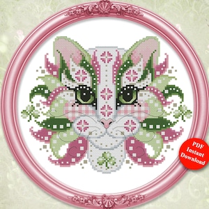 May include: A cross-stitch pattern featuring a colorful cat design in a pink, green, and white color scheme. The design is set within a pink circular frame. The text "Colorful Cats" and "March" are displayed above the image. The design is by Pamela Kellogg.