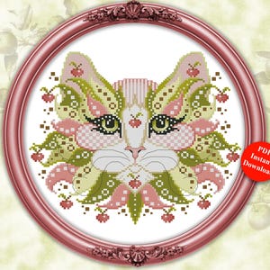 May include: A cross-stitch pattern titled Colorful Cats September by Kitty Me Designs, featuring a stylized cat face in shades of pink, green, and white with small apple motifs, enclosed in a round pink frame with a PDF Instant Download badge.
