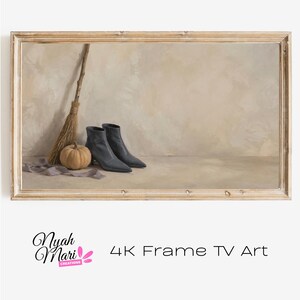 May include: A rectangular digital artwork for a television screen featuring a pair of dark gray ankle boots, a small tan pumpkin, and a rustic wooden broom, all framed in a light-colored wood border with the text Nyah Mari Creations 4K Frame TV Art.