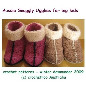 May include: Three pairs of crocheted slippers in pink, brown, and beige. The slippers have a fluffy white cuff and a black trim. The text "Aussie Snuggly Ugglies for big kids" is at the top of the image. The text "crochet patterns - winter downunder 2009 (c) crochetroo Australia" is at the bottom of the image.