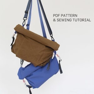 May include: Two hanging messenger bags. The top bag is brown, with a rolled top. The bottom bag is blue. Both bags have black straps and silver hardware. The text "PDF PATTERN & SEWING TUTORIAL" is visible.