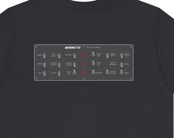 May include: Black t-shirt with a rectangular graphic featuring the word "MOONETTE" and various light bulb icons. The graphic includes red accents and text, creating a minimalist design. The shirt is made of a soft material.