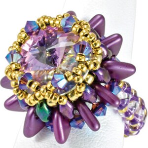 May include: A purple and gold beaded ring with a large, clear, faceted gemstone in the center. The ring has a starburst design with purple beads and gold accents.