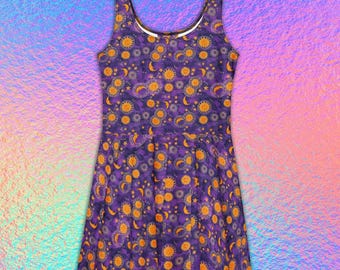 May include: A sleeveless skater dress featuring a deep purple background with a repeating pattern of golden yellow suns, crescent moons, and small stars. The garment has a scoop neckline and a flared skirt that falls from the waistline.