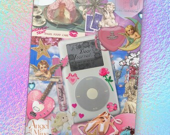 May include: A collage featuring a white iPod with the text "Dear Journal...", surrounded by pink hearts, roses, and a pink guitar-shaped object. Other elements include a cake, cherubs, and the MTV logo, all set against a holographic background.