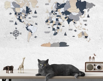 May include: A gray cat sits on a wooden table in front of a wooden world map with a compass. The map is decorated with black, gray, and beige pieces. There are also wooden animal figurines on the table, including a giraffe and a bear.