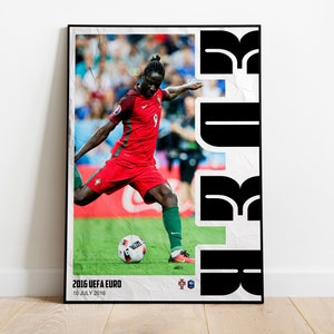 May include: A black and white poster with a photo of a soccer player kicking a ball. The player is wearing a red and green jersey with the number 9 on it. The poster has the text "2016 UEFA EURO 10 JULY 2016" at the bottom.