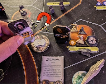 May include: Magnetic ring and leader stands for a board game, featuring a character token of Princess Leia, a circular metal ring, and a Post Bounty card. The game board displays various miniature figures, starships, and planetary locations.
