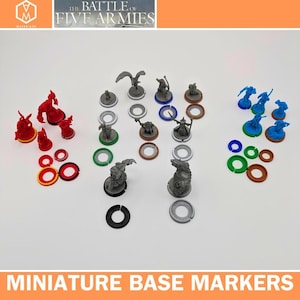 May include: A selection of miniature figurines and base markers. The figurines are in red, blue, and grey. The base markers are in red, yellow, green, blue, and brown. The text "THE BATTLE OF FIVE ARMIES" is at the top.