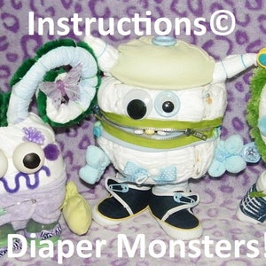 May include: Three diaper monster baby shower gifts. One is green and yellow, one is blue and white, and one is purple and green. The monsters are made of diapers, fabric, and other baby items. The text "Diaper Monsters!" is at the bottom of the image.