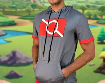 May include: A gray hooded short-sleeved shirt with a red and white graphic design. The shirt has a red band at the bottom and a kangaroo pocket.