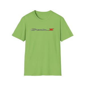 May include: A lime green t-shirt with a silver and red "Gremlin X" logo printed on the front.