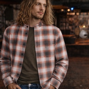 kurt cobain in a dress shirt Kurt Cobain dressed with defiance, favoring worn-out cardigans, tattered knits, and thrift-store finds that rejected the polished veneer of mainstream fashion. He also embraced radically gender-fluid dressing, appearing in women's clothing on