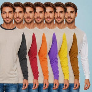 May include: Seven long-sleeved shirts with contrasting coloured sleeves. The shirts are beige with black, red, orange, purple, yellow, brown, and white sleeves.