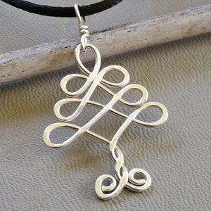 May include: A silver wire pendant necklace with a tree design. The pendant is made of twisted wire and has a delicate, intricate design.