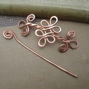 May include: A copper wire hair pin set with a decorative twisted wire design and a simple straight pin.