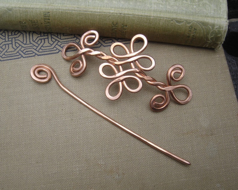 May include: A copper wire hair pin set with a decorative twisted wire design and a simple straight pin.
