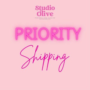 May include: Pink background with the words "Studio Olive" and "Personalized Fashion Accessories" in a light pink font. The word "PRIORITY" is in a bright pink neon font, and the word "Shipping" is in a cursive pink font.