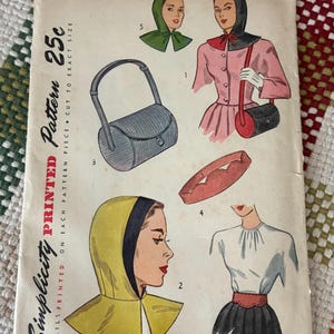 May include: A vintage Simplicity pattern envelope 1766 for one size accessories. The paper cover features illustrations of a hooded capelet, a cylindrical handbag, a scalloped belt, and a blouse. Text includes Simplicity Printed Pattern 25c.