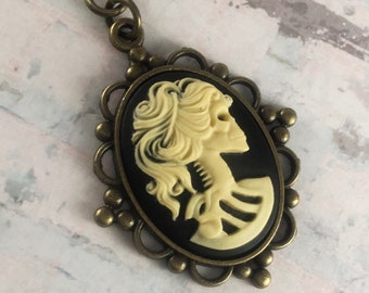Black and Ivory Whimsigoth Skeleton Cameo Necklace with Antiqued Brass