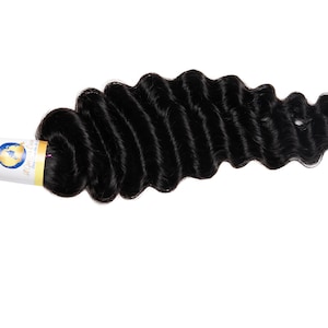 May include: A bundle of black loose wave human hair extensions. The hair is tied with a black elastic band and has a label that says "All About Hair".