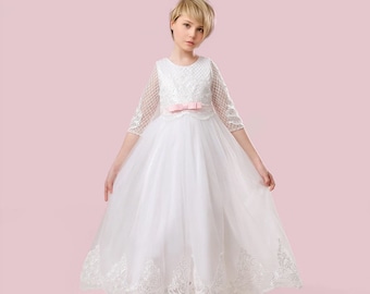 Lace white bridesmaid dress for teens.White lace dress with a pink sash.Long mesh sleeves.Clothing for special children's events.
