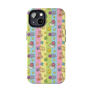 May include: A colorful phone case with a repeating pattern of cartoon cats, dice, and stars. The background features vertical stripes in yellow, pink, blue, and green. The case has a glossy finish and a camera cutout.
