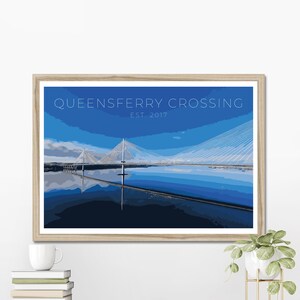 May include: A framed print of a blue and white illustration of the Queensferry Crossing bridge in Scotland. The text "Queensferry Crossing Est. 2017" is at the top of the print.