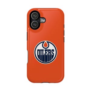May include: An orange phone case with the Edmonton Oilers logo in white and navy blue. The case has a dual-camera cutout and black side buttons. The Oilers logo is a stylized oil drop with the team name.