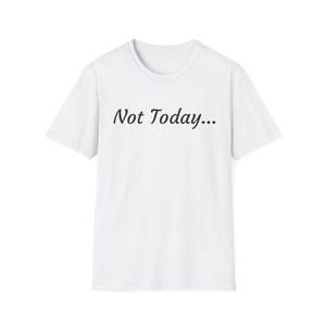 May include: A white t-shirt featuring the text "Not Today..." in a black cursive font. The shirt has a round neck and short sleeves. The fabric appears to be a soft, possibly cotton material, suitable for casual wear.
