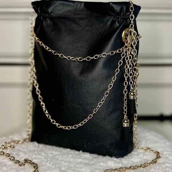 Woman’s faux leather black evening mini bag, with gold chain embellishment